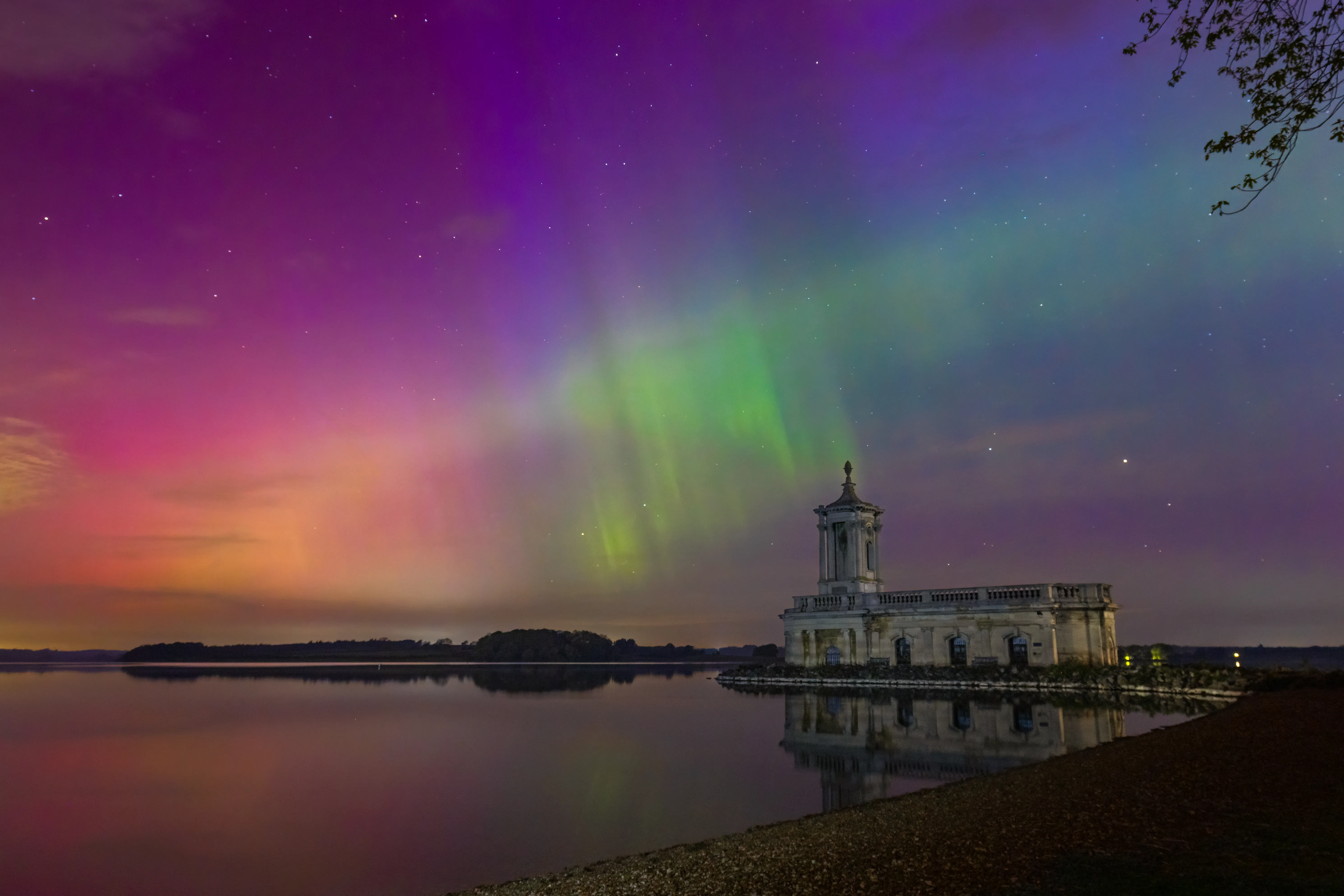 Northern Lights illuminating the sky above Normanton Church
