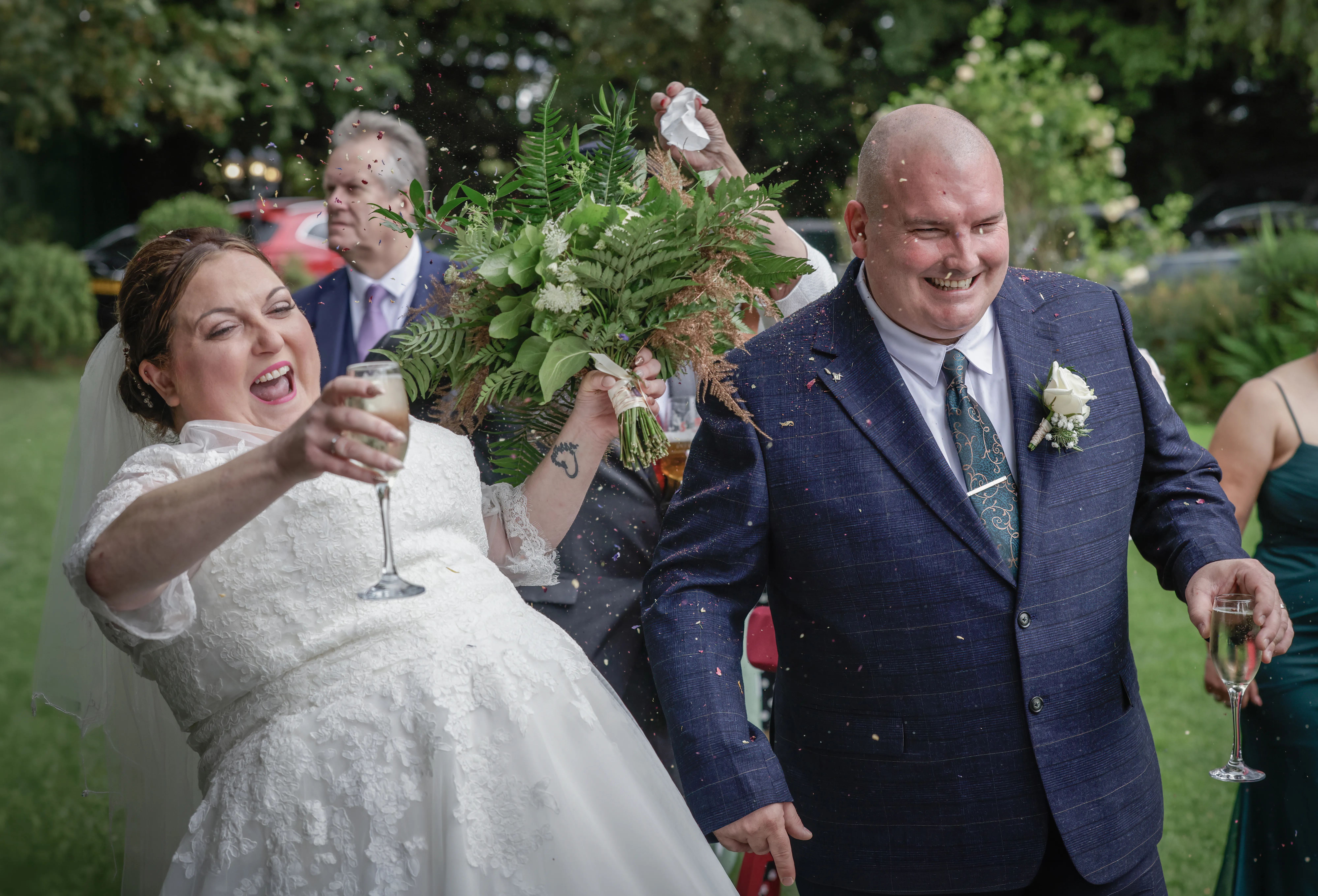 Newlyweds celebrating together surrounded by confetti